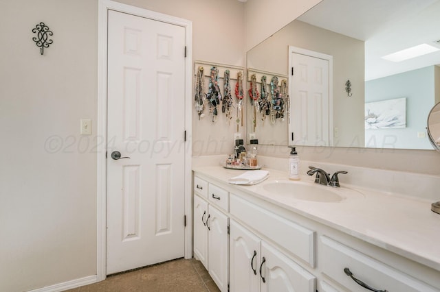 bathroom featuring tile patterned flooring and vanity