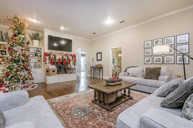 living room with a fireplace, wood-type flooring, and crown molding