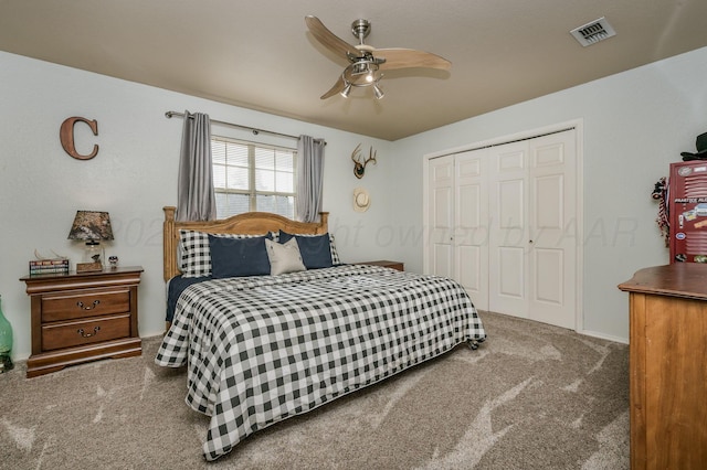 carpeted bedroom with a closet and ceiling fan