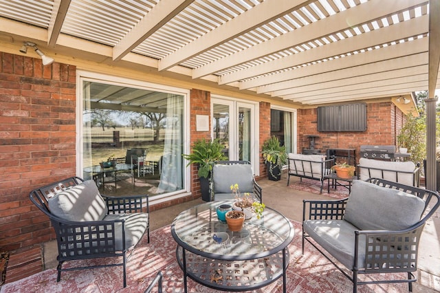 view of patio featuring area for grilling and a pergola