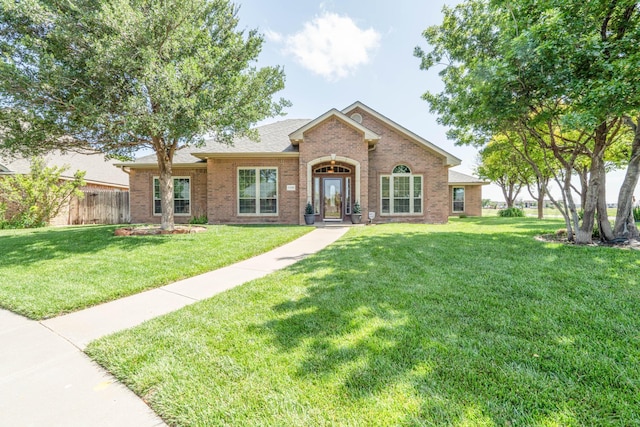8309 Plymouth Dr, Amarillo, TX 79119 - view of front facade featuring brick siding and roof with shingles