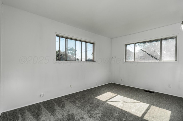 213 Union St, Borger, TX 79007 - empty room featuring healthy amount of natural light and dark carpet