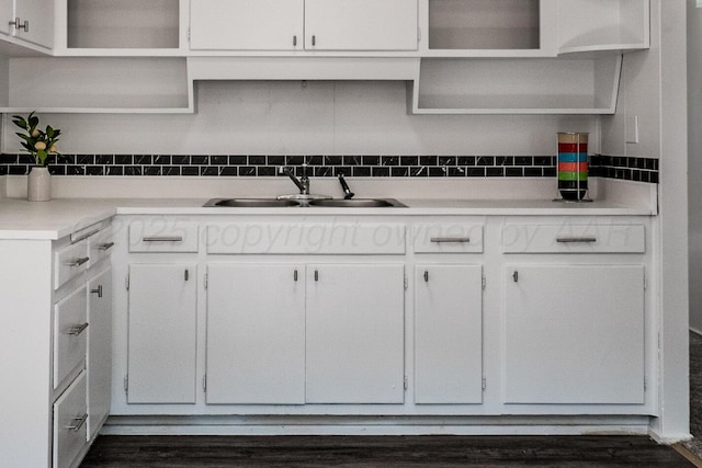 213 Union St, Borger, TX 79007 - kitchen featuring open shelves, decorative backsplash, white cabinetry, and dark wood-style floors