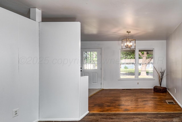 213 Union St, Borger, TX 79007 - unfurnished room featuring wood finished floors and a chandelier