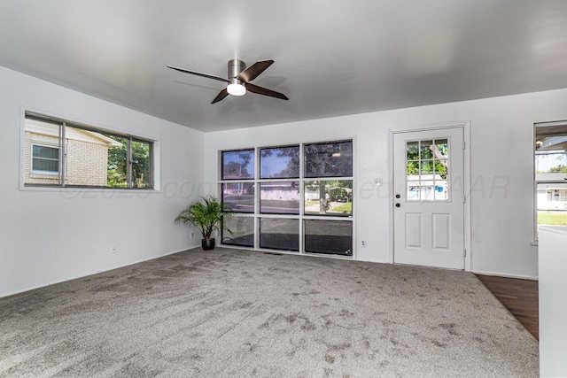 213 Union St, Borger, TX 79007 - unfurnished living room with a ceiling fan, plenty of natural light, and carpet flooring