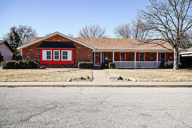 ranch-style home with covered porch and brick siding