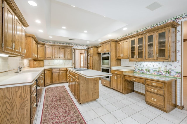 3457 Colchester Pl, Amarillo, TX 79121 - kitchen featuring stainless steel double oven, a raised ceiling, light countertops, brown cabinets, and a sink