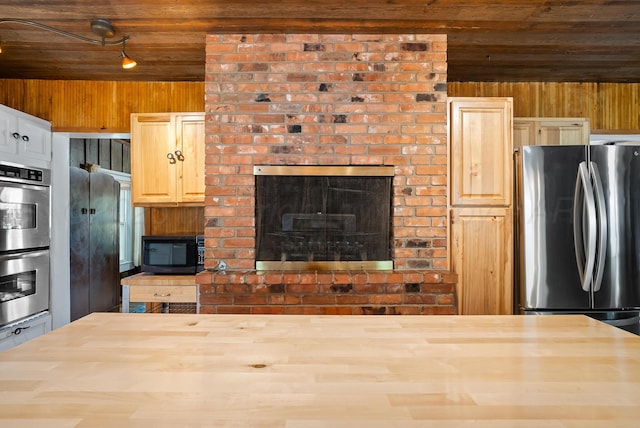 kitchen featuring wood counters, black appliances, wooden walls, and wooden ceiling