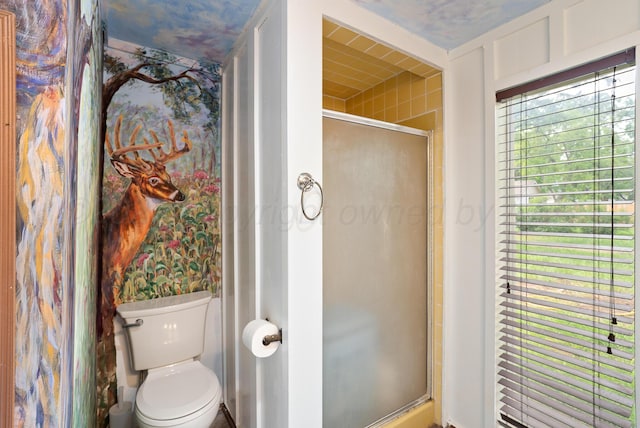 full bathroom with a shower stall and toilet