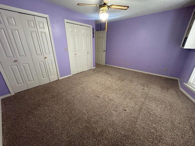 7906 Merchant Dr, Amarillo, TX 79121 - unfurnished bedroom featuring a textured ceiling, carpet floors, multiple closets, and baseboards