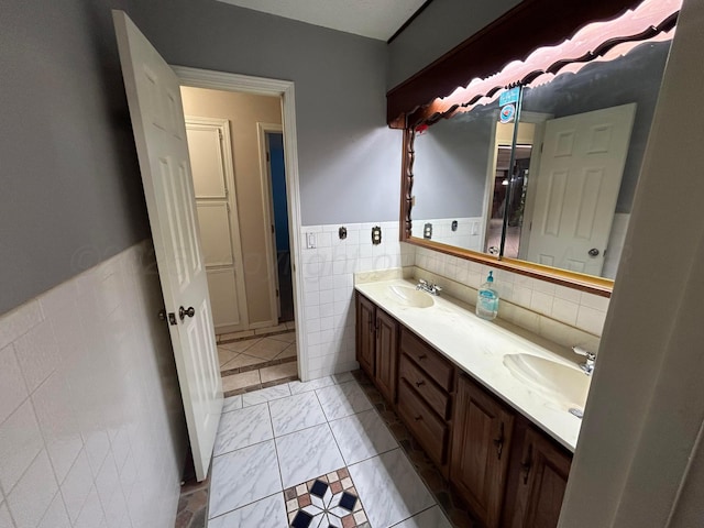 7906 Merchant Dr, Amarillo, TX 79121 - full bath with tile walls, wainscoting, a sink, and double vanity