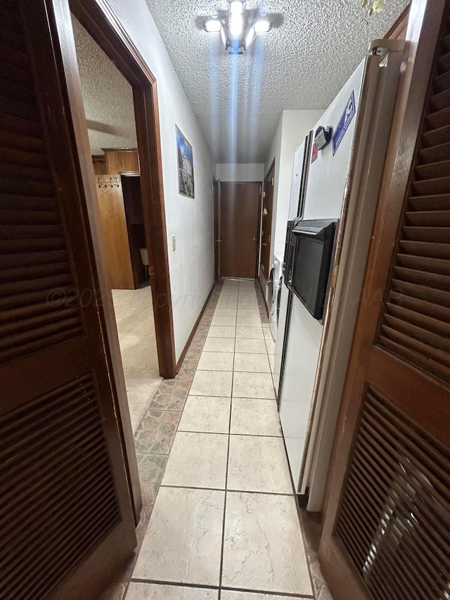 7906 Merchant Dr, Amarillo, TX 79121 - hall featuring baseboards, a textured ceiling, and light tile patterned floors