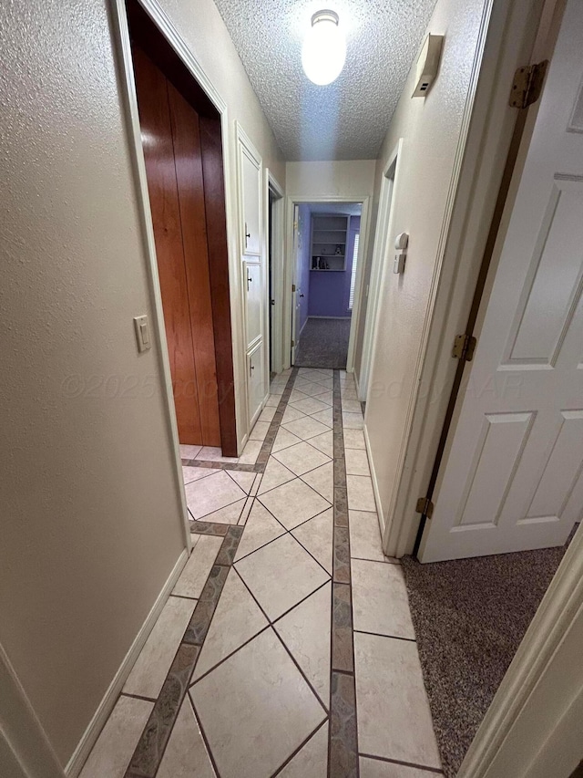7906 Merchant Dr, Amarillo, TX 79121 - hall featuring baseboards, a textured ceiling, and light tile patterned floors