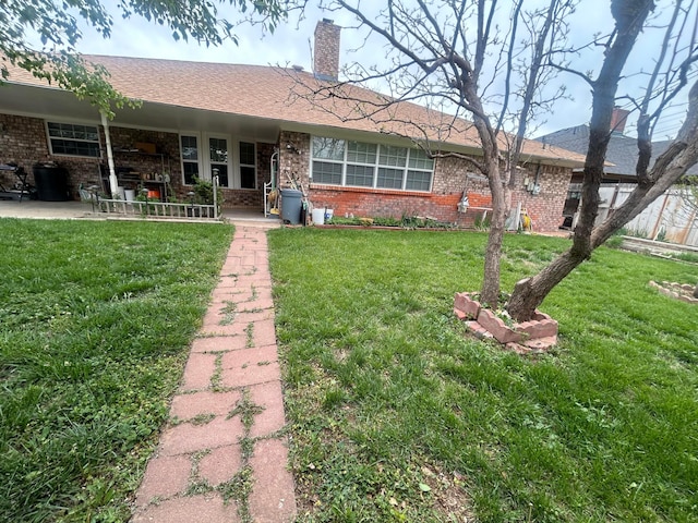 7906 Merchant Dr, Amarillo, TX 79121 - ranch-style house with a patio area, a chimney, brick siding, and a front yard