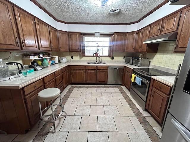 7906 Merchant Dr, Amarillo, TX 79121 - kitchen with a sink, a textured ceiling, appliances with stainless steel finishes, and crown molding