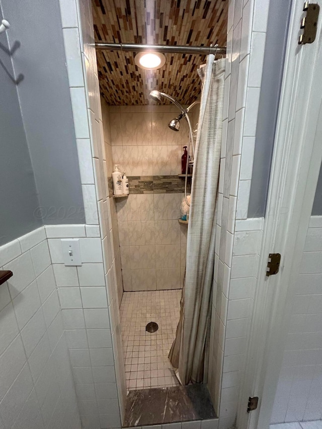7906 Merchant Dr, Amarillo, TX 79121 - full bath with tile patterned flooring, tile walls, a wainscoted wall, and a stall shower