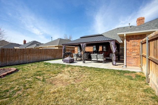 8103 El Paso Dr, Amarillo, TX 79118 - rear view of property featuring a gazebo, a patio area, brick siding, a shingled roof, and an outdoor living space