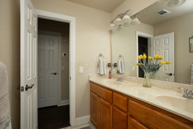 8103 El Paso Dr, Amarillo, TX 79118 - full bathroom featuring double vanity and baseboards