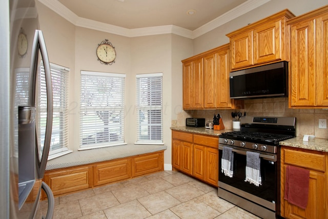 8103 El Paso Dr, Amarillo, TX 79118 - kitchen with stainless steel appliances, decorative backsplash, ornamental molding, light stone countertops, and brown cabinetry