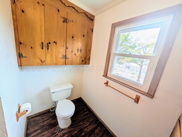 bathroom with hardwood / wood-style floors, crown molding, and toilet