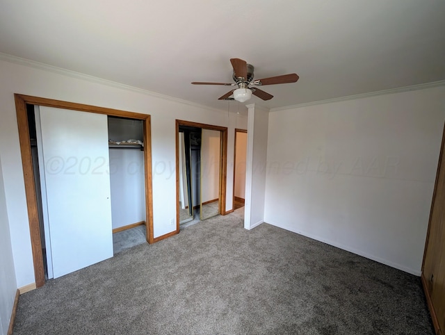 unfurnished bedroom featuring carpet, multiple closets, ornamental molding, and ceiling fan