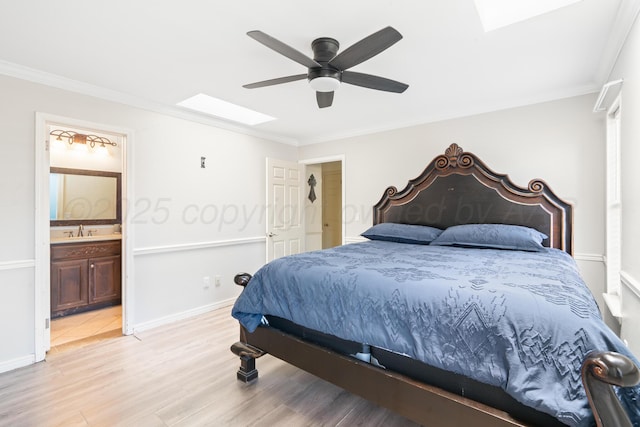 1321 Buena Vista St, Amarillo, TX 79106 - bedroom featuring ornamental molding, a skylight, light wood-type flooring, ensuite bathroom, and ceiling fan