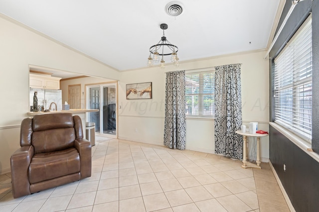 1321 Buena Vista St, Amarillo, TX 79106 - living room featuring light tile patterned floors, lofted ceiling, and a chandelier