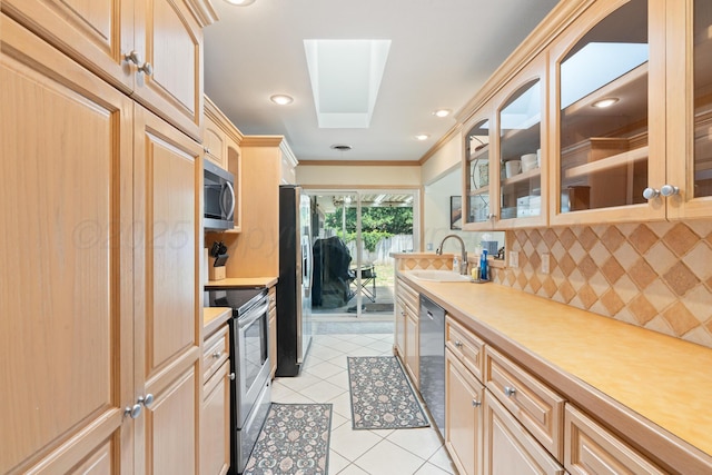 1321 Buena Vista St, Amarillo, TX 79106 - kitchen featuring appliances with stainless steel finishes, light tile patterned flooring, decorative backsplash, light countertops, and glass insert cabinets