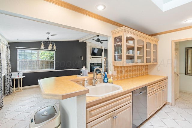 1321 Buena Vista St, Amarillo, TX 79106 - kitchen featuring stainless steel dishwasher, ornamental molding, light tile patterned floors, glass insert cabinets, and a glass covered fireplace
