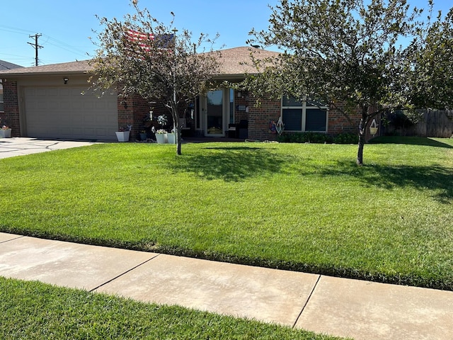 view of front of home featuring a garage and a front lawn