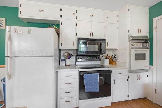 3515 Linda Dr, Amarillo, TX 79109 - kitchen with white appliances, tasteful backsplash, light countertops, and white cabinetry