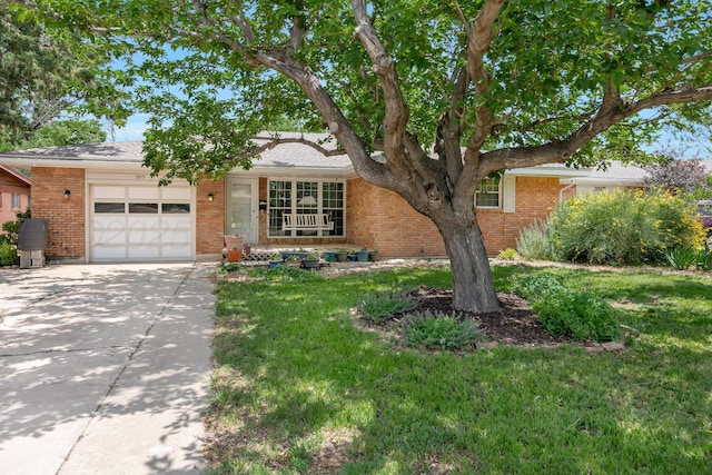 3515 Linda Dr, Amarillo, TX 79109 - view of front facade featuring a garage, driveway, brick siding, and a front yard