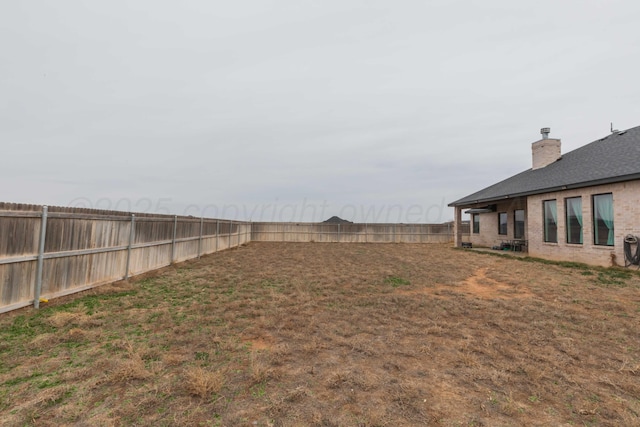 view of yard with a fenced backyard