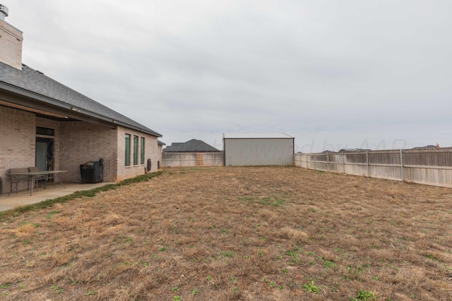 view of yard with a fenced backyard and a patio area