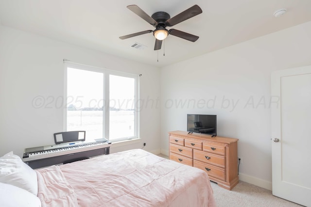 bedroom featuring baseboards, visible vents, ceiling fan, and light colored carpet