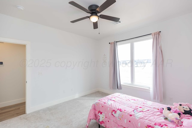 bedroom featuring baseboards, visible vents, a ceiling fan, and carpet