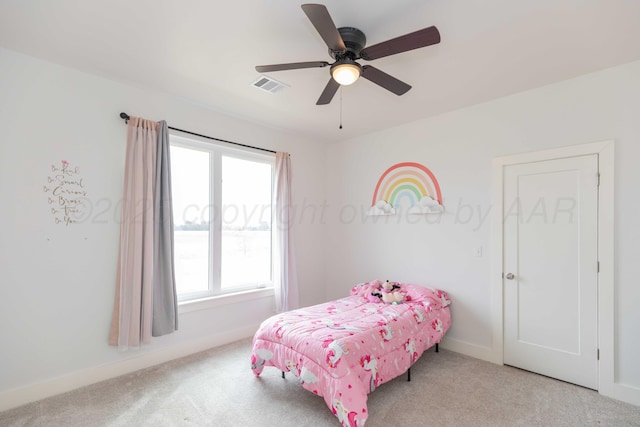 carpeted bedroom with a ceiling fan, visible vents, and baseboards
