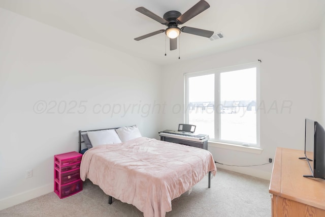 carpeted bedroom featuring visible vents, a ceiling fan, and baseboards