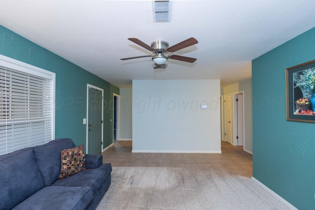 3604 SE 30th Ave, Amarillo, TX 79103 - carpeted living area with a ceiling fan, tile patterned floors, and baseboards