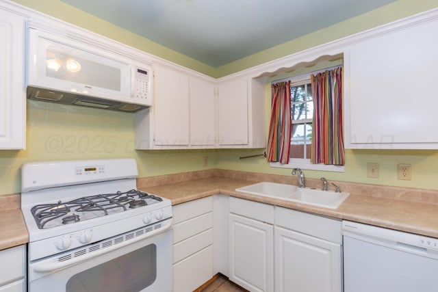 3604 SE 30th Ave, Amarillo, TX 79103 - kitchen with white appliances, a sink, white cabinets, and light countertops