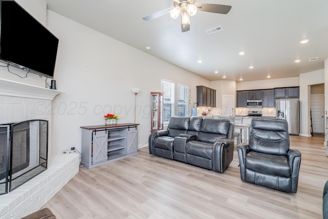 1800 Morningside Ave, Amarillo, TX 79118 - living area featuring a ceiling fan, light wood finished floors, a brick fireplace, and recessed lighting