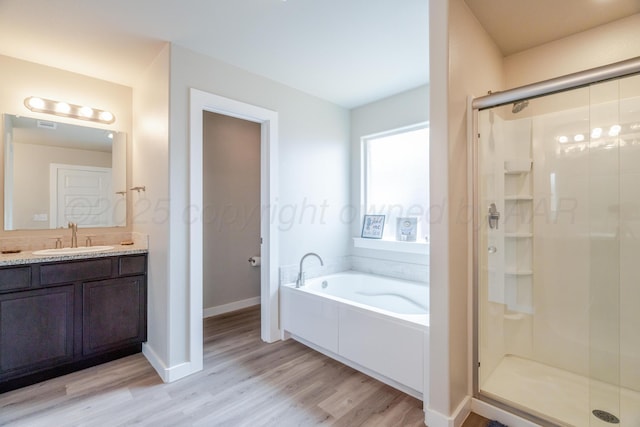 1800 Morningside Ave, Amarillo, TX 79118 - full bath featuring wood finished floors, a garden tub, a stall shower, and vanity