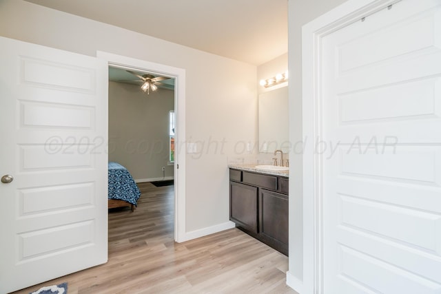 1800 Morningside Ave, Amarillo, TX 79118 - bathroom with vanity, wood finished floors, ceiling fan, and connected bathroom