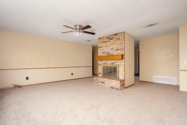 unfurnished living room featuring visible vents, a fireplace, and a textured ceiling