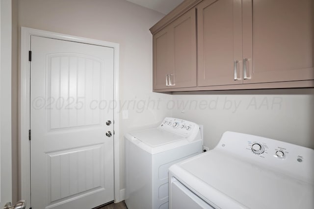 laundry room featuring washer and clothes dryer and cabinets