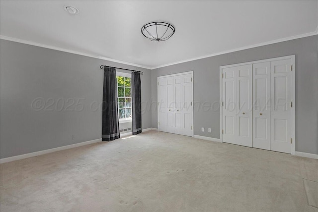 1805 S Julian Blvd, Amarillo, TX 79102 - unfurnished bedroom featuring two closets, crown molding, baseboards, and carpet floors