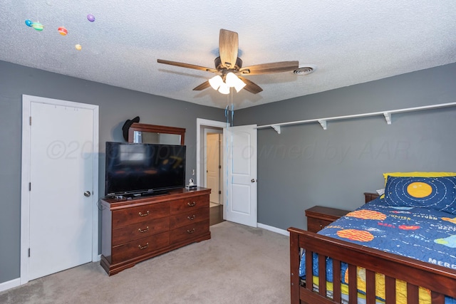 carpeted bedroom with ceiling fan, baseboards, a textured ceiling, and visible vents