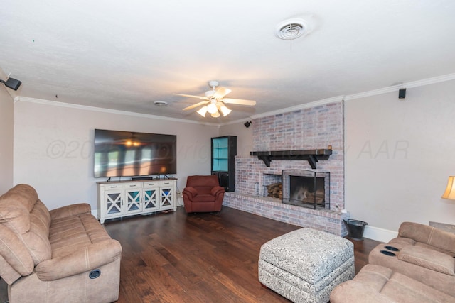 living area featuring a ceiling fan, wood finished floors, visible vents, and a fireplace