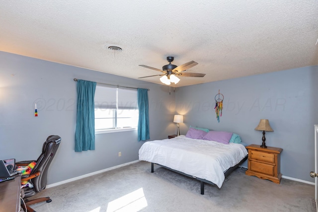 carpeted bedroom with baseboards, visible vents, a textured ceiling, and ceiling fan