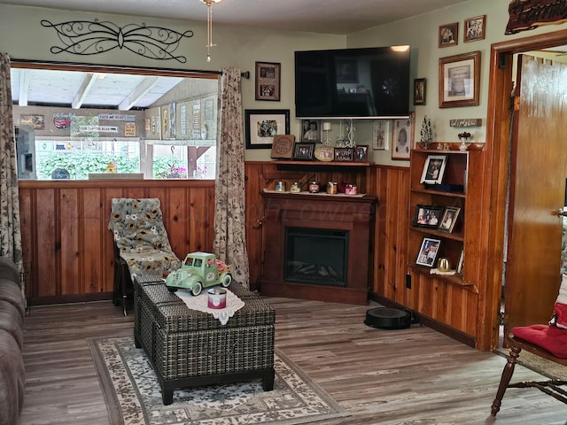3621 NE 19th Ave, Amarillo, TX 79107 - living area featuring a fireplace, wood finished floors, wooden walls, and a wainscoted wall